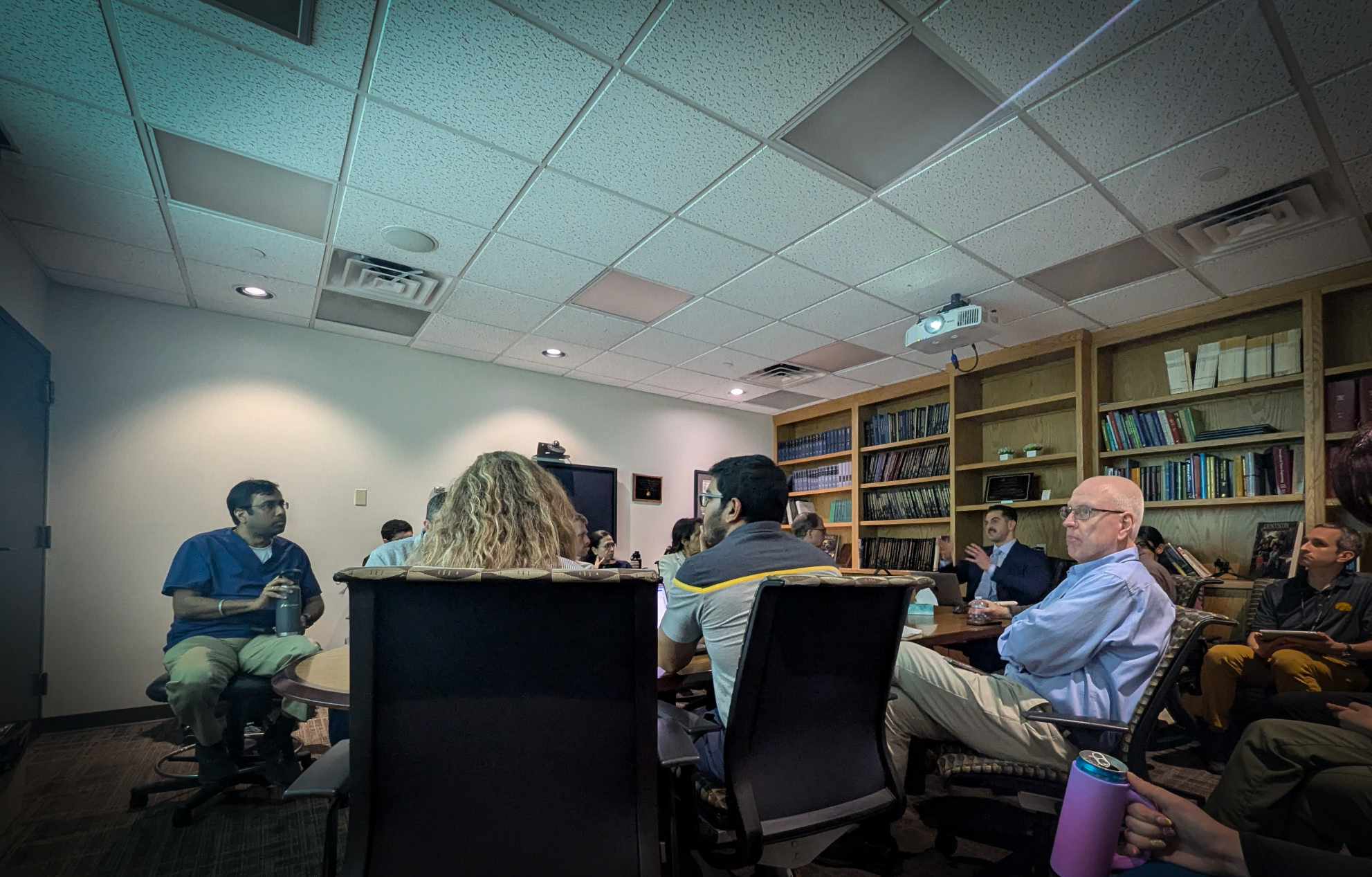 Dentists seated in a teaching session, listening to a presentation
